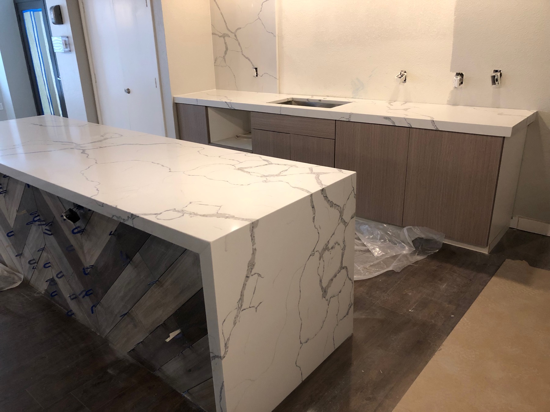 Custom vanity renovation with veined stone surfaces