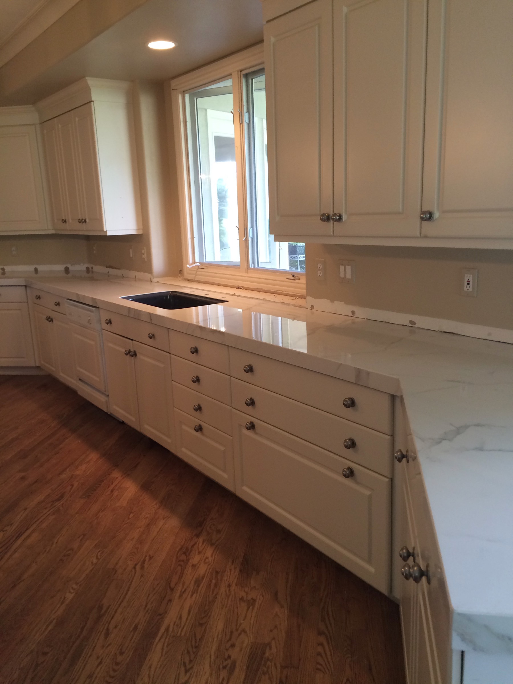 Finished custom kitchen with stone countertops and detailed cabinetry