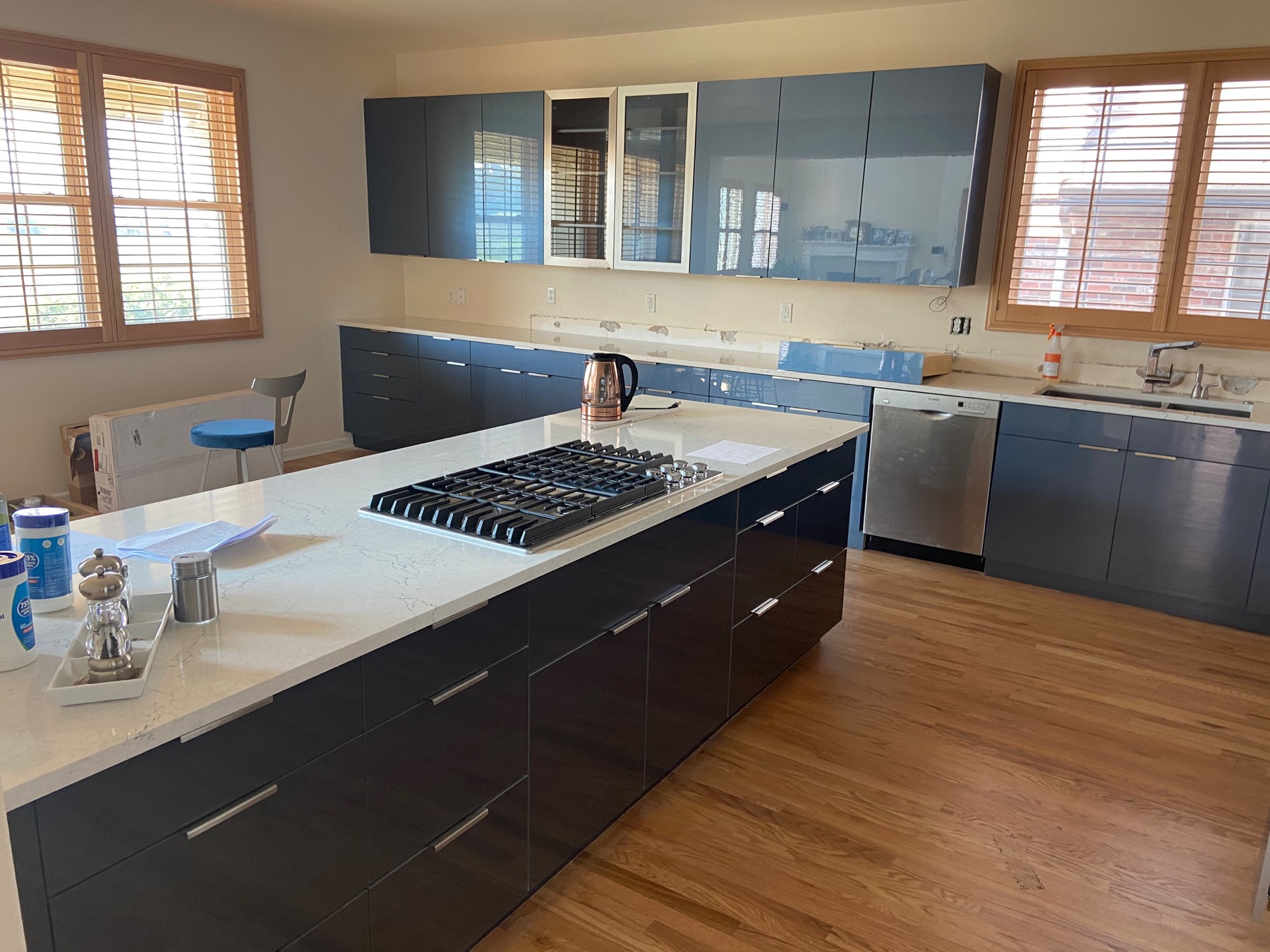 Contemporary kitchen with dark cabinetry and a white island